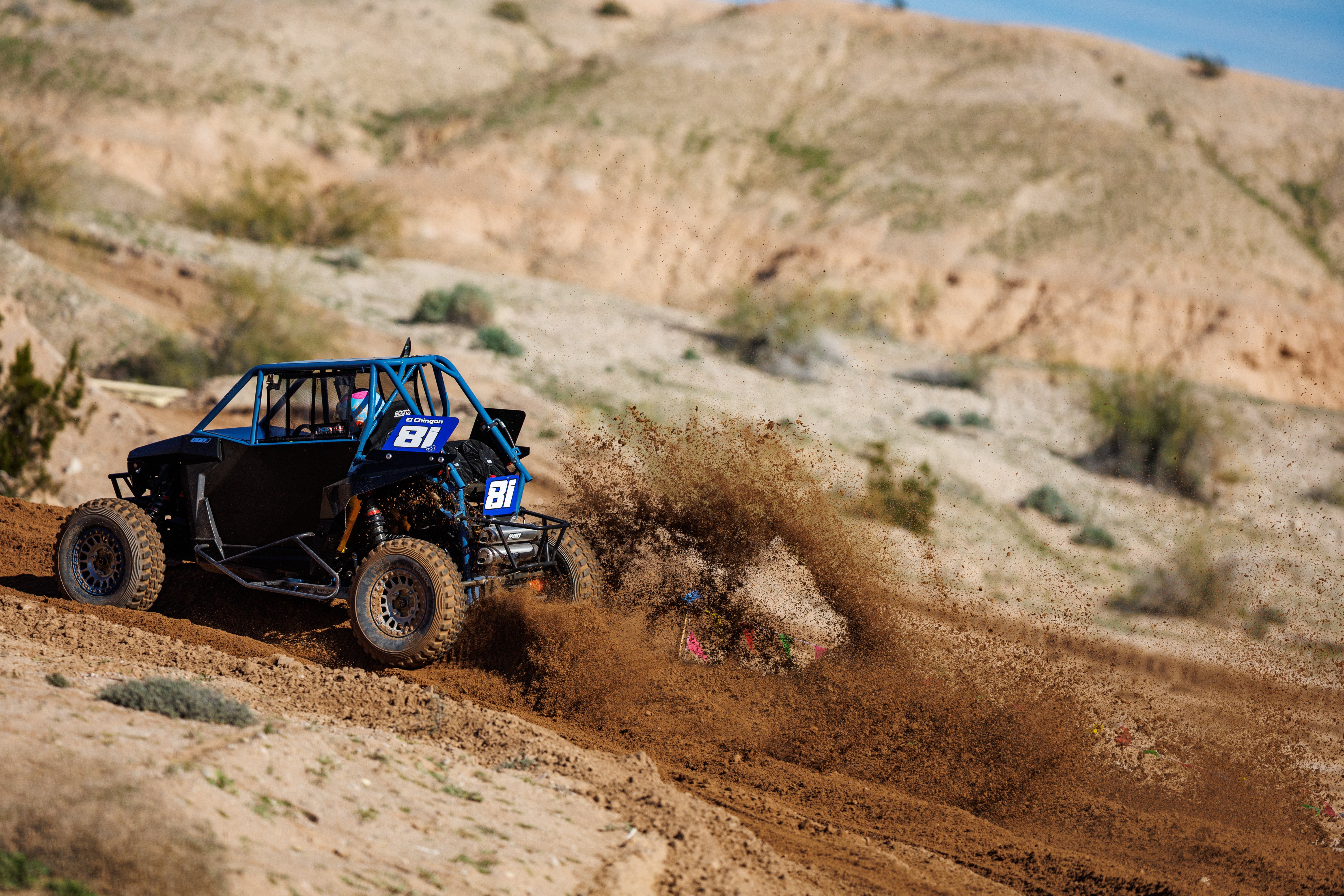 Number 81 race car throwing a dramatic wall of dirt