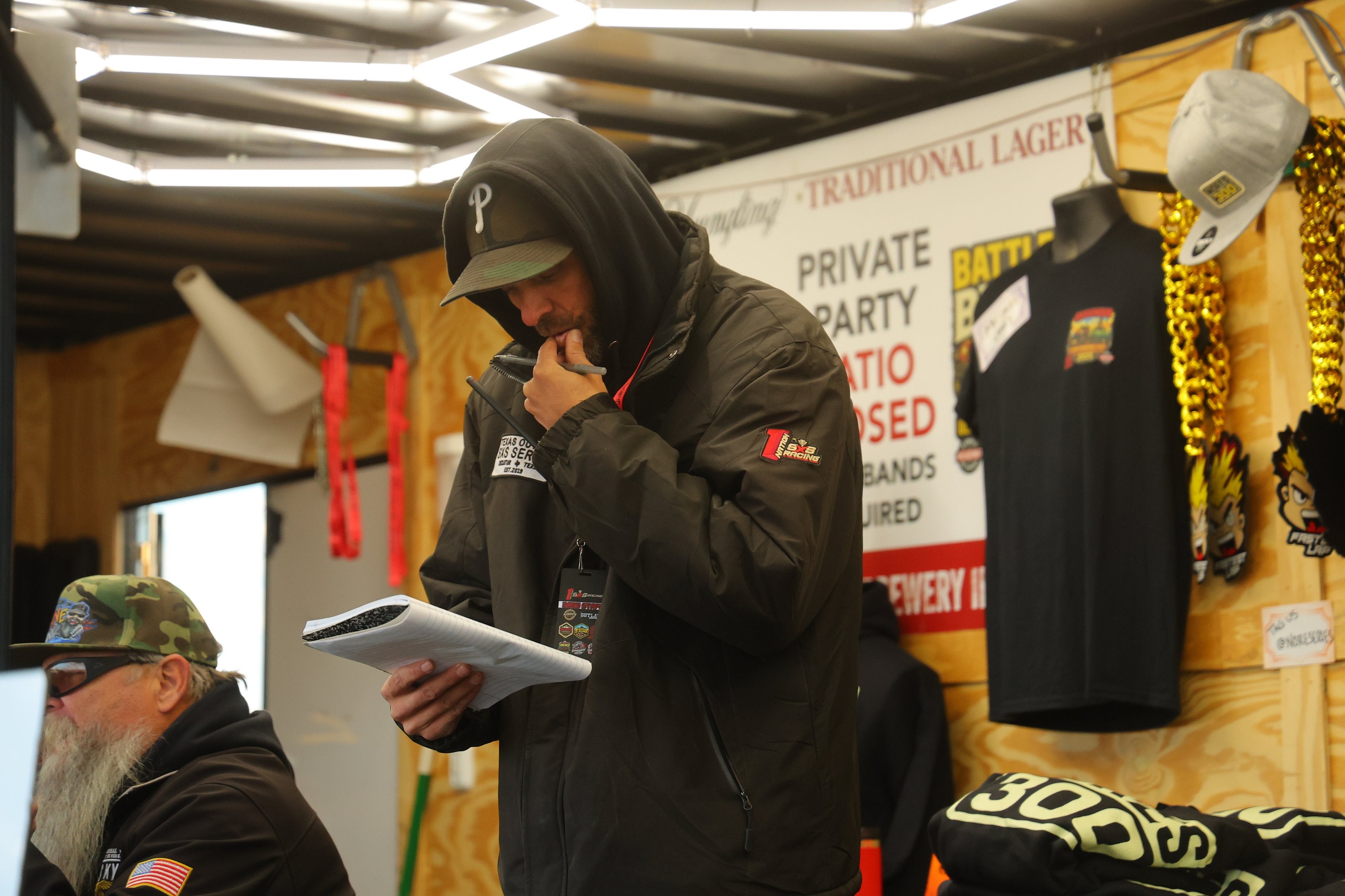 Race official reviewing notes indoors