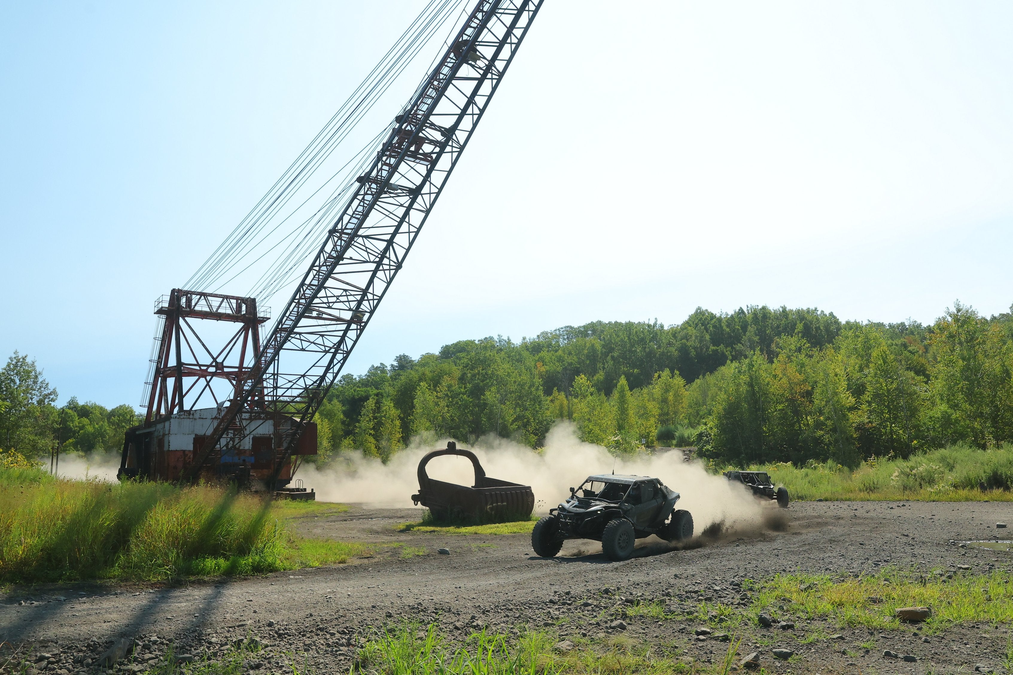 Side-by-side racing past a large industrial crane
